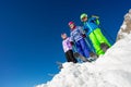 Low angle view on ski kids in snow over blue sky Royalty Free Stock Photo