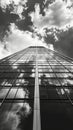 Low angle view of a skyscraper against cloudy sky in monochrome Royalty Free Stock Photo