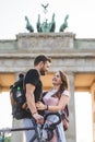 low angle view of smiling female traveler embracing boyfriend