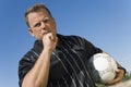 Low angle view of soccer referee showing yellow card against blue sky Royalty Free Stock Photo