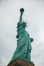 Low-angle view of the Statue of Liberty standing against a cloudy sky Royalty Free Stock Photo