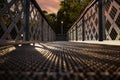 Low angle view of a steel metal footbridge in late evening sunshine