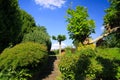 Low angle view on stone steps in german garden with two levels and green trees against blue sky - Germany Royalty Free Stock Photo