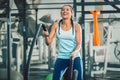 Strong woman exercising with battle ropes during functional training Royalty Free Stock Photo