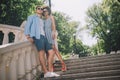 low angle view of stylish multicultural couple standing on stairs