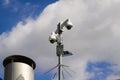 Low angle view on surveillance cameras against blue sky and clouds in city center of Venlo