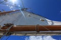 A low angle view of a tall ship sail against a bright blue sky taken looking up from the deck of the boat Royalty Free Stock Photo