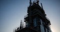 Skyscraper construction site with scaffolding and crane against a clear sky building architecture Royalty Free Stock Photo
