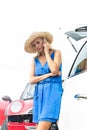 Low angle view of tensed woman using cell phone by broken down cars