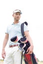 Low angle view of thoughtful mid-adult man carrying golf club bag against clear sky Royalty Free Stock Photo