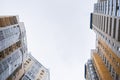 Low angle view tops of facades of vivid modern gray-yellow residential buildings .