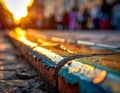 Lowangle view of tram tracks on cobblestones with golden sunset bokeh Royalty Free Stock Photo