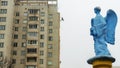 Low angle view of a transparent statue of blue angel. Religion or LGBTQ symbol. Transgender concept.