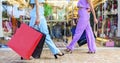 Low angle view of two happy women walking with shopping bags in front of shop window store. beautiful girls having fun on summer Royalty Free Stock Photo