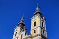 Low-angle view of towers of sunlit Baroque church in Hungary Royalty Free Stock Photo