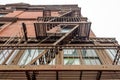 Low Angle View of Typical New York City Apartments with Fire Escape Ladders in Manhattan Royalty Free Stock Photo