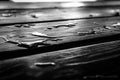 low angle view of water droplets and pooling on water resistant decking or table plank boards background Royalty Free Stock Photo