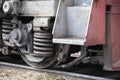 Low angle view of wheel mechanism of modern train locomotive on tracks. Steampunk, techno, power concept