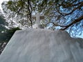 Low angle view of a white cross of a small roadside chapel