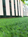 Low Angle View of White Fence and Green Artificial Grass Royalty Free Stock Photo