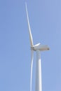 Low angle view of wind turbine against partly cloudy blue sky Royalty Free Stock Photo