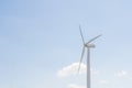 Low angle view of wind turbine against partly cloudy blue sky Royalty Free Stock Photo
