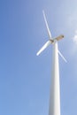 Low angle view of wind turbine against partly cloudy blue sky Royalty Free Stock Photo