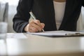 Low angle view of a woman signing contract Royalty Free Stock Photo