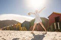 Low angle view of woman walking on sand against clear sky Royalty Free Stock Photo