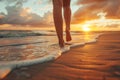 Low angle view of womans feet walking on a sandy beach on sunset Royalty Free Stock Photo