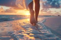 Low angle view of womans feet walking on a sandy beach on sunset Royalty Free Stock Photo