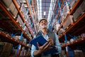 Low angle view of worker is smiling and holding a clipboard Royalty Free Stock Photo