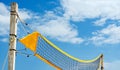 Yellow filet beach volleyball against blue sky . Relaxing activities on vacation at the sea