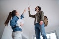 Low angle view of young couple moving and planning in new flat, new home and relocation concept.