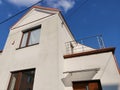 Low angle of a white-walled house under a clear blue sky Royalty Free Stock Photo