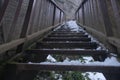 Low angle of wooden bridge, stairs and steps covered by snow Royalty Free Stock Photo