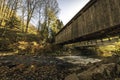 Low angle of wooden covered bridge in autumn Royalty Free Stock Photo