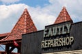 Low angle of "Faulty repairshop" lunapark attraction during the summertime