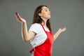 Low angle of young female supermarket employee making winner gesture