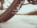 Low ankle photo of rear hweel of mtb in snowdrift. Picture taken within winter bike trip