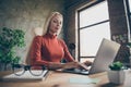 Low below angle view photo of qualified business lady working on her project by using laptop sitting at desktop