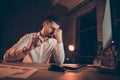 Low below angle view photo of tired businessman with head hurting migraine eyes aching putting glasses off sitting at