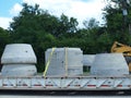 A Low Boy Trailer Delivers Risers For A Sewer Project Royalty Free Stock Photo