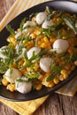 Low calorie salad of corn, baby mozzarella and arugula close-up. vertical