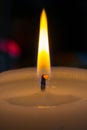 Candle burns at dusk, a candle fire on a black background Royalty Free Stock Photo