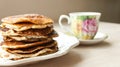 Low Carb Keto Diet Pancakes from almond coconut flour stack on white plate and cup of cocoa