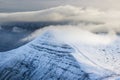 Low cloud and fog over a cold, snow covered mountain Cribyn, Wales Royalty Free Stock Photo