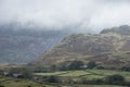 Low cloud hanging over Lake District landscape giving a dramatic image looking into the distant hills and mountains Royalty Free Stock Photo