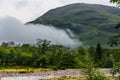 Low cloud and mist over a forest with mountain backdrop (Glencoe, Scotland Royalty Free Stock Photo