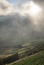 Low clouds over the Miradouro da Serra do Cume revealing the typical plots with walls landscape of Terceira Royalty Free Stock Photo